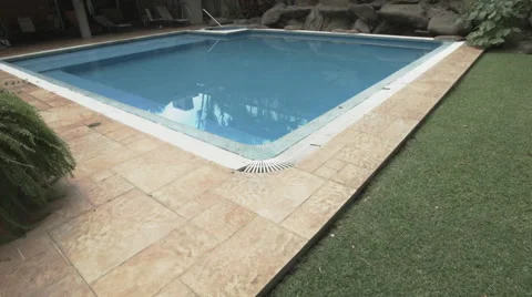 A garden fitted with a big pool and tropical trees 스톡 동영상 48787755