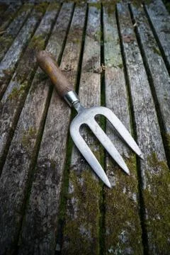 Garden hand fork rustic table Stock Photos