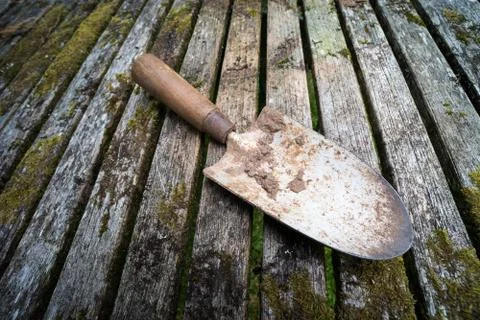 Garden hand trowel rustic table Stock Photos