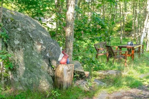 Garden idyll under trees Stock Photos