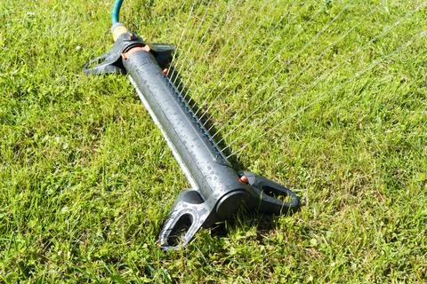 Garden irrigation system lawn. Automatic lawn sprinkler watering green gras.. Stock Photos