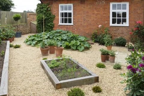 Garden with oak sleeper raised bed Stock Photos