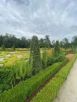 A garden with a path and hedges Stock Photos