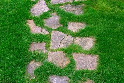 Garden path made of natural rough stone different size rock. Stock Photos