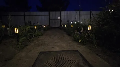 Garden path at night illuminated by multiple decorative solar lanterns creating Stock-Footage 342922106