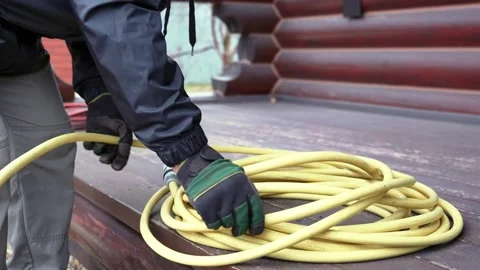 Garden preparation: coiling a hose Video stock 256305987