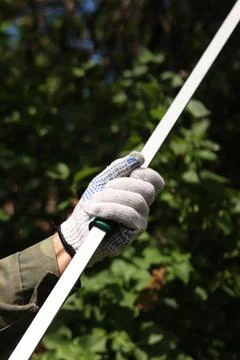 Garden pruner (long-handled pruner), in the hands of a gardener close-up Photos