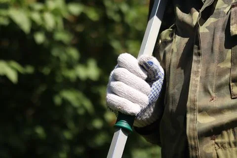 Garden pruner (long-handled pruner), in the hands of a gardener close-up Photos
