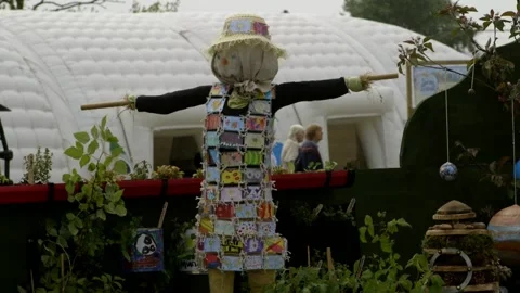 Garden Scarecrow as decorative elements in landscape design on spring festival Stock Footage 144979812