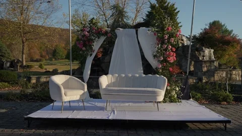 Garden Setting With Romantic Decor, Chic Floral Arch With Ambient Lighting And Stock Footage 323777088