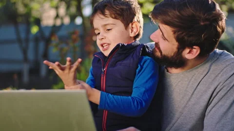 In the garden smiling large cute small boy with his father have a good time Stock Footage 135669389
