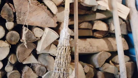 Garden tools like broom for tree branches, rake and shovel in storage building Stock Footage 302196501