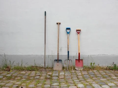 Garden Tools on Cobble Surface with Weed Stock Photos