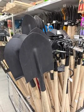 Garden tools lined up for selection in a bright retail store space Stock Photos