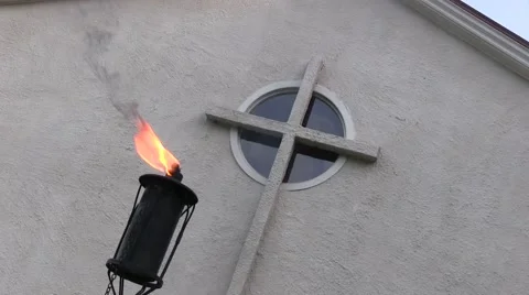 Garden torch burning with cross in background Stock Footage 46154336