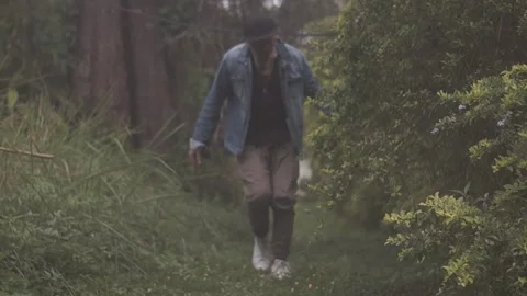 In The Garden walking men in denim jacket Stock Footage 243095812