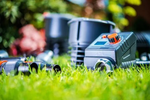 Garden Watering System Elements in the Grass. Closeup Photo. Building Automat Stock Photos