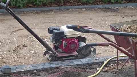 Garden Work Made Easier: Using a Soil Compactor for Efficient Landscaping P.. Stock Footage 265159078