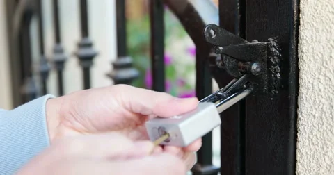 Garden Wrought Iron Gate Unlock Padlock (4K) Stock Footage 46029079