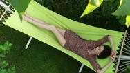 Garden. A Young Brunette Woman Resting In A Hammock. Top View. Slow Motion. Hd Stock Footage