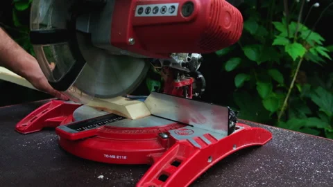 In the garden. A young man cuts a board with a Stock Footage 201309554