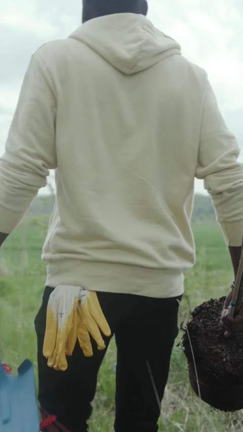 A Gardener Carrying Various Tools While Engaging with Nature in a Peaceful Stock Footage 314157414
