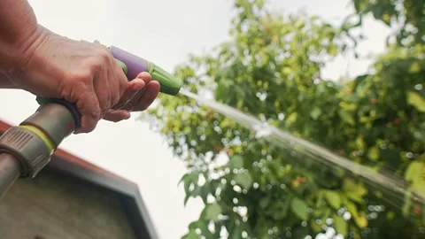 Gardener changes running water flow Stock Footage 157136339