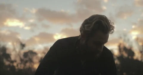 Gardener checking organic vegetable crops at sunrise Stock Footage 76404729