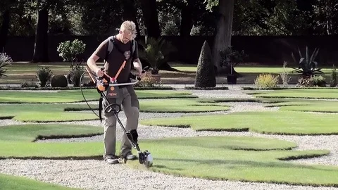 Gardener cut the side of the border. Stock Footage 84199269
