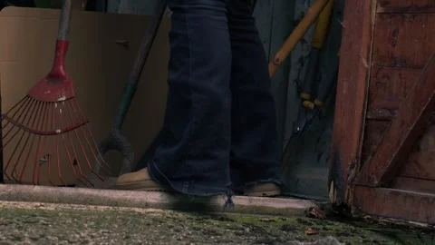 Gardener gets rake from garage Video stock 263909964