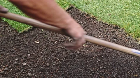 Gardener Grading Out Soil With A Rake. SLOW MOTION. Planting green grass lawn. 스톡 동영상 140369396