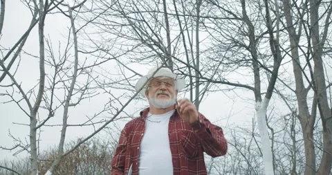 Gardener looking up, trimming tree branches. Stock Footage 250072978