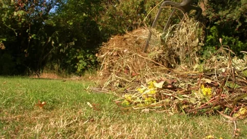Gardener making and turning compost with garden fork Video stock 344747148