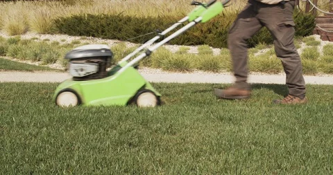 Gardener operating scarifying machine in grass lawn (A) Stock Footage 103710155