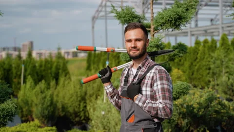 Gardener Taking a Break with Pruning Shears on Shoulder Stock Footage 287655231