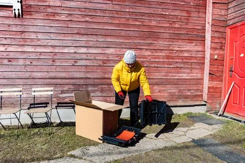 Gardener taking compost bin components and plastic sections out of shipping.. Stock Photos