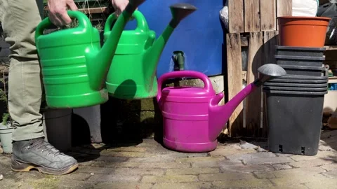 Gardener Using Rain Barrel and Watering Cans in Backyard Garden Vídeos de archivo 332301016