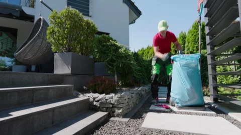 Gardening Project in a Modern Backyard With Stone Work and Landscaping Stock Footage 284357468