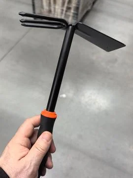 Gardening tool held in hand for easy planting and soil preparation Stock Photos