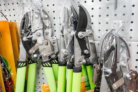 Gardening tools with pruning shears and loppers featuring green handle Photos