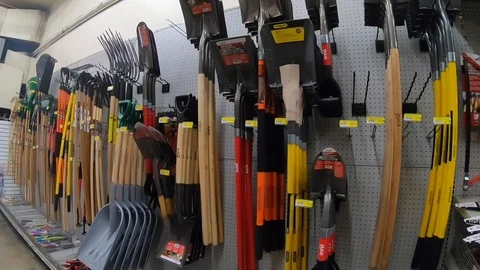 Gardening tools, shovel, rakes and pitchfork in hardware store. Stock Footage