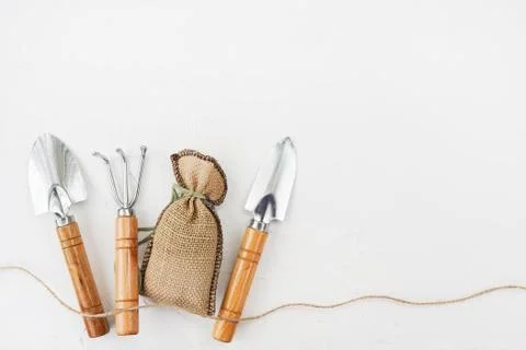 Gardening tools on white table. Spring in the garden concept, top view, flat  스톡 사진