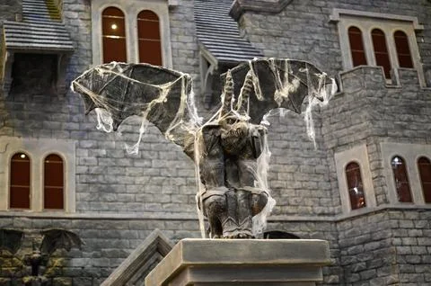 Gargoyle statue on the background of the castle.	 Stock Photos