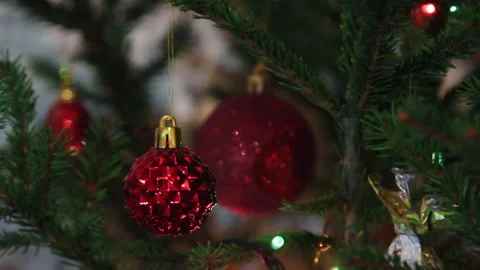 The garland on the Christmas tree illuminates the red shiny balls. Stock Footage 145208648