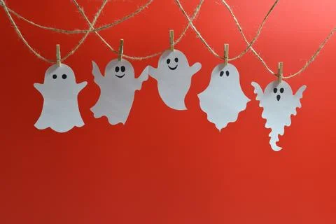 A garland with cute ghosts on a red background Stock Photos