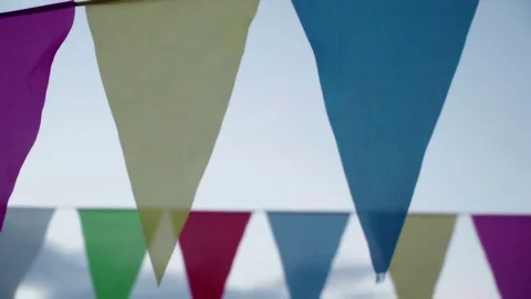 Garland of multi colored flags of triangular shape sways in evening sky Stock Footage 85040689