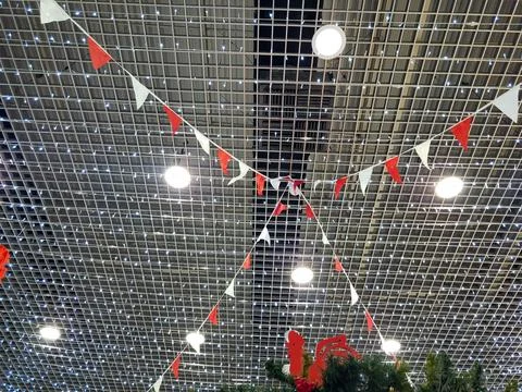 Garlands of colorful triangular flags hang from the ceiling. New Years Foto stock