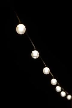 Garlands of light bulbs in the dark Stock Photos