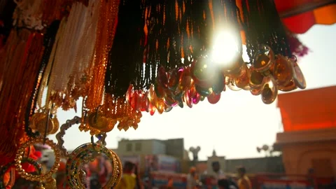 Garlands withe Sun flare hanging in the market Video stock 214320232