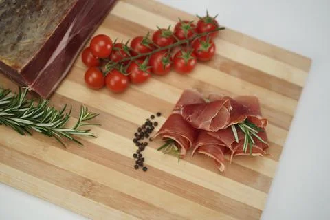 Garlic and pepper with prosciutto on a plate Stock Photos